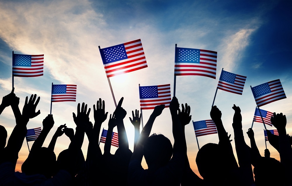image of people holding up American flags