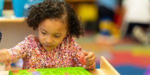 K-5 student putting a puzzle together