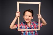 Boy holding picture frame