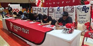 Several foorball players sign in in 