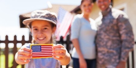 Family with girl holding American flag