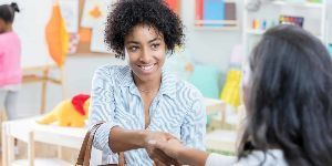 teacher and parent shaking hands
