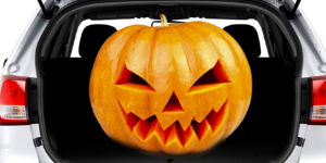 Jack-o-lantern sitting in a car trunk