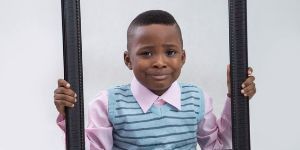 boy holding empty picture frame
