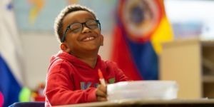student at desk with glasses