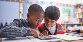 two students using an electronic device