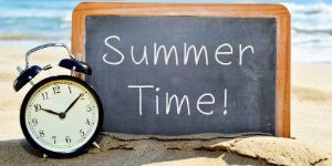 Summer Time on a Chalkboard in the Sand Nest to a Clock