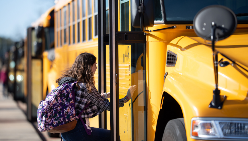 girl getting on bus