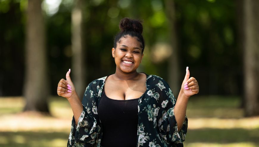 Girl with 2 thumbs up