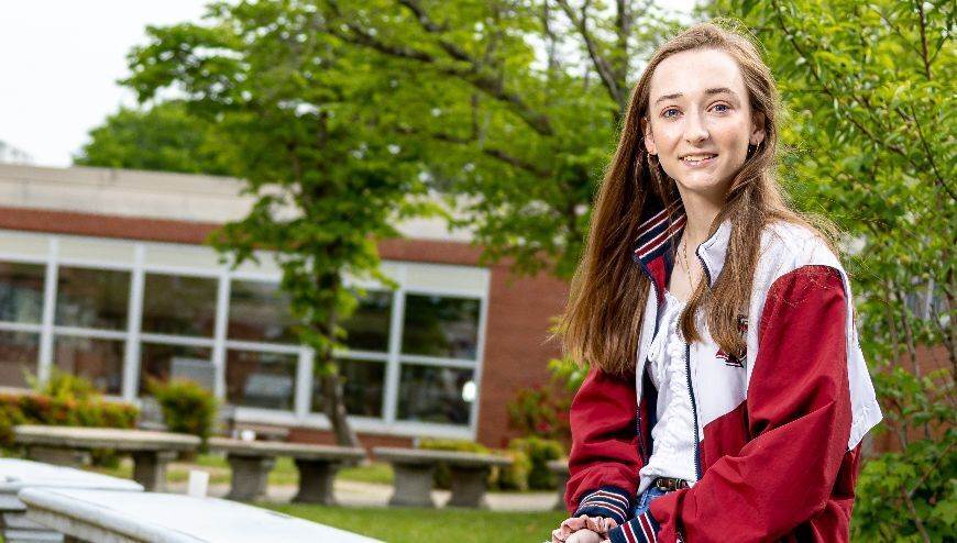 Student in front of School