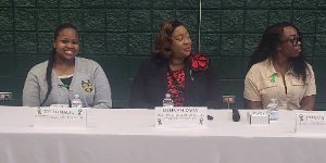 3 students sitting by the table