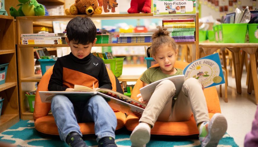 two elementary students reading