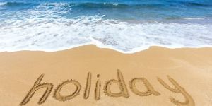 holiday text on the sand