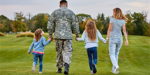 image of miliary family holding hands 
