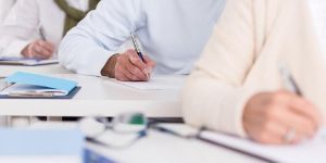 image of students' hands writing.