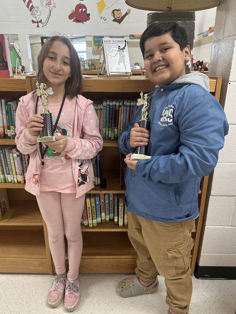 boy and girl holding trophies