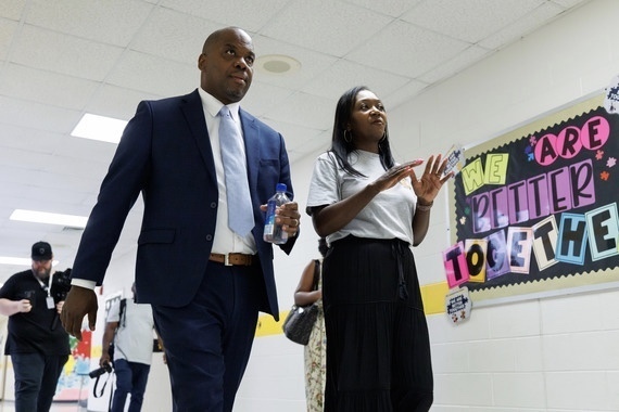 Dr. Bracy walking hallway with Staff