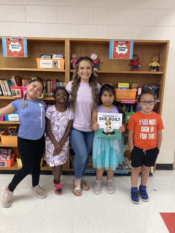 students holding a book