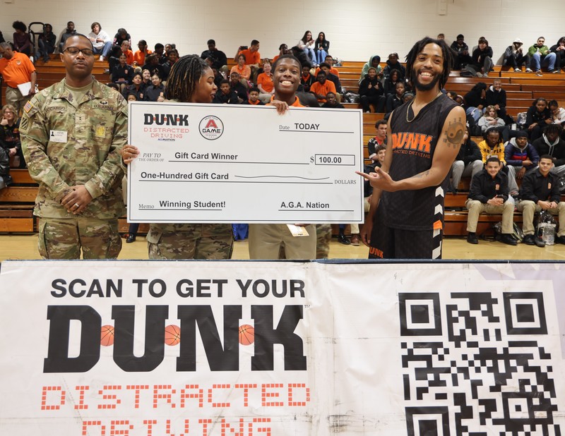 Members of the U.S. Army pose with the student gift card winner and A.G.A. Nation Acrobatic Dunker