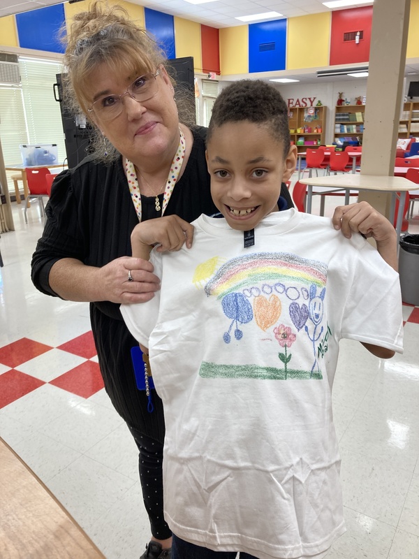student and teacher with shirt
