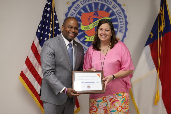 CCS Superintendent Dr. Eric Bracy and Pine Forest High School Assistant Principal Mandy McMillan accepting the Committed Community Support Award on Tabitha Robinson's behalf