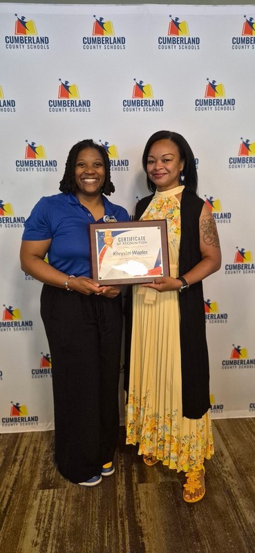 two ladies holding award