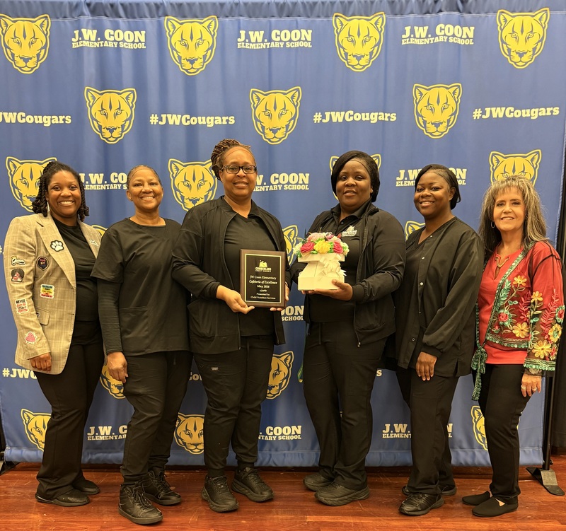 Ladies holding award wearing black