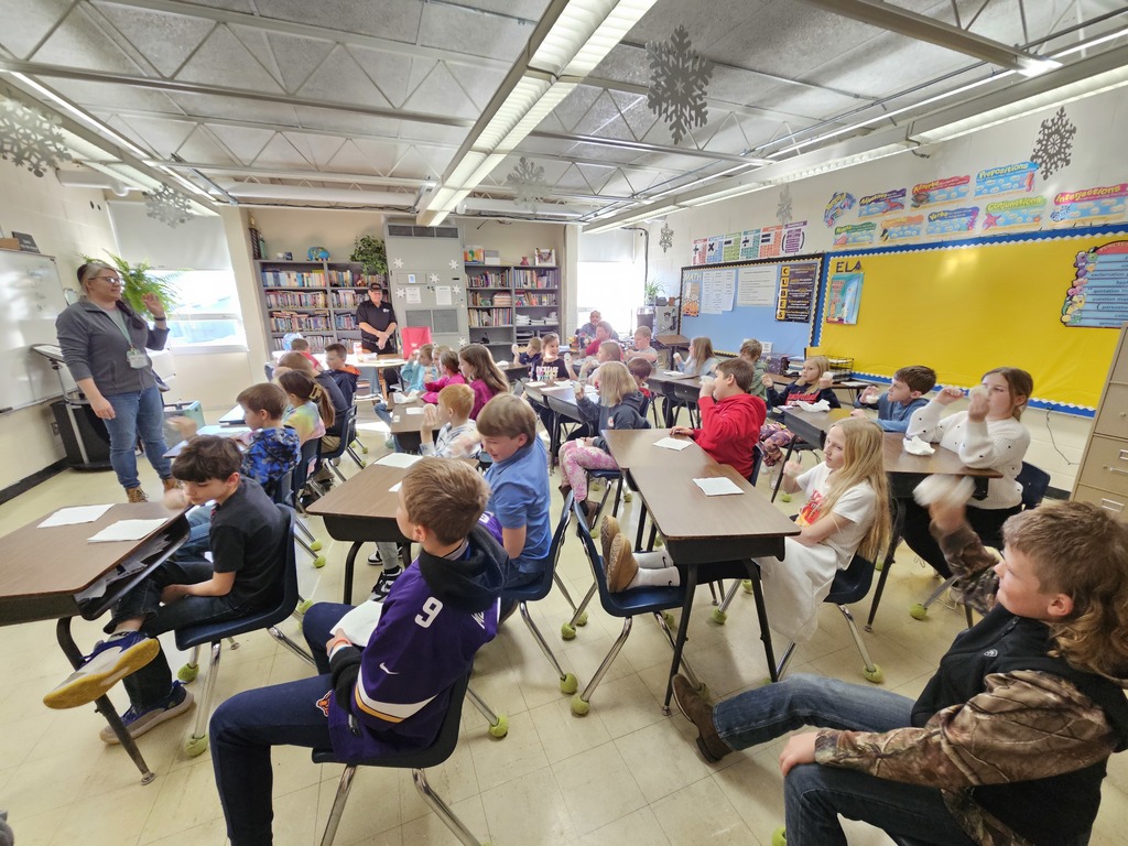 Ag Teacher showing students how to make butter.