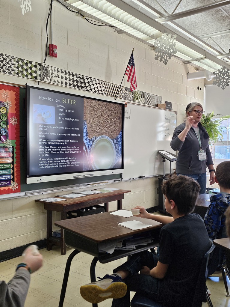 Ag Teacher showing students how to make butter.