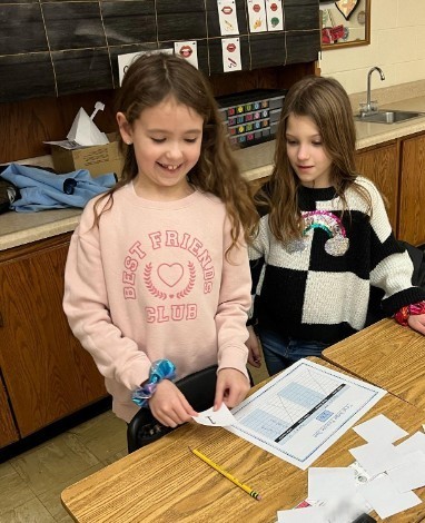 Students working on a 100 day math game.