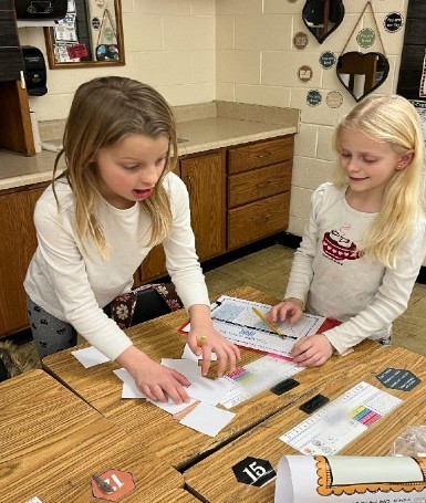 Students working on a 100 day math game.