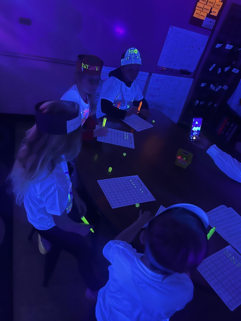 Students playing glow in the dark games.
