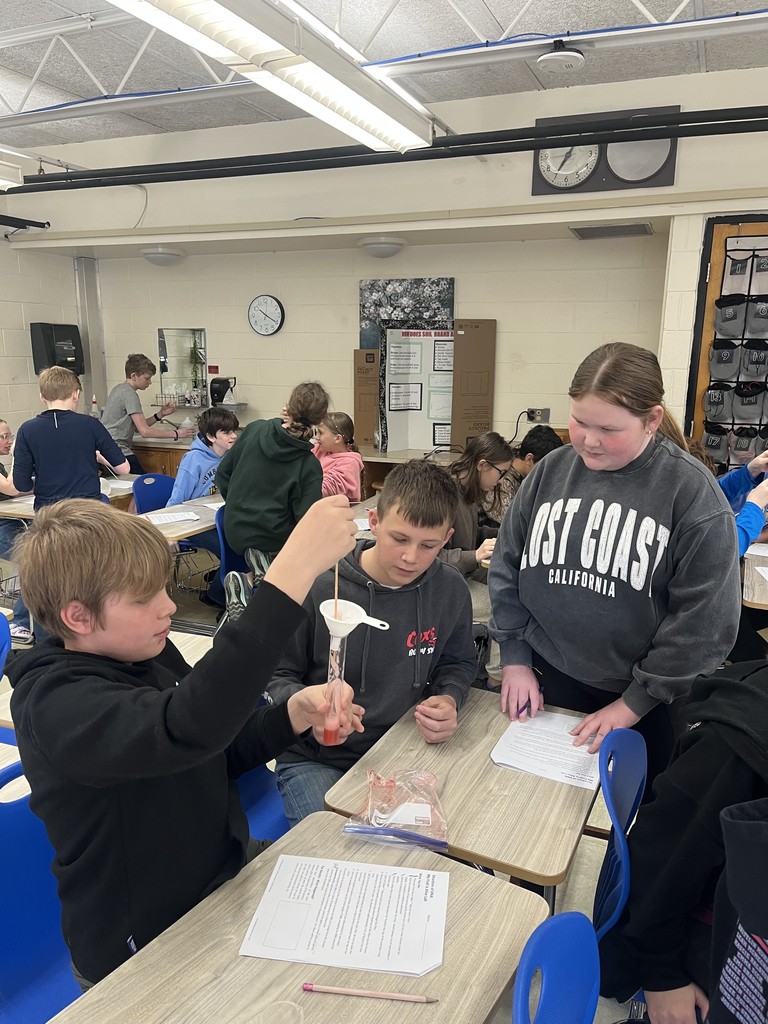 Students are extracting DNA from a strawberry in a science experiment.