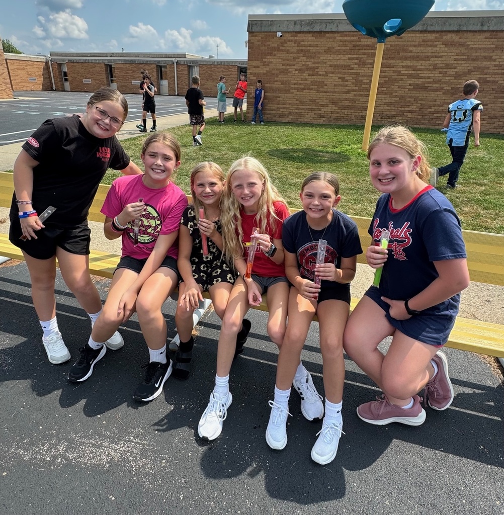 Six girls are eating popsicles. 