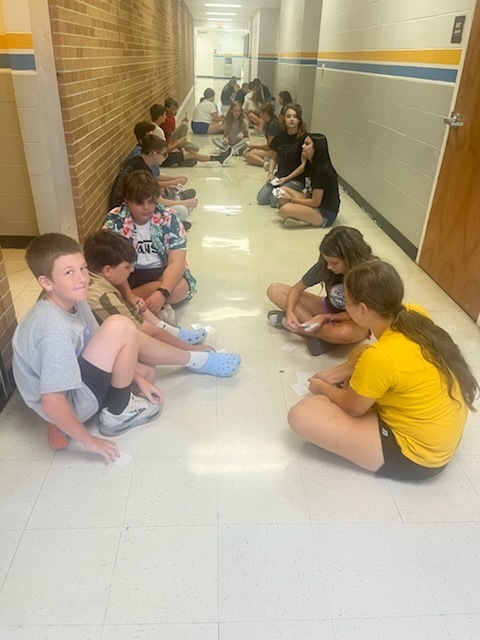 Students are playing Go Fish only using ASL nonverbal gestures. 