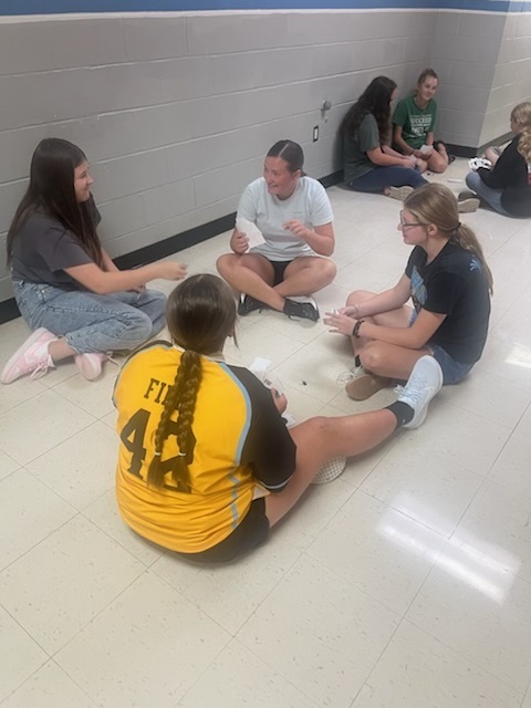 Students are playing Go Fish only using ASL nonverbal gestures. 