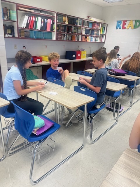 Students are playing Go Fish only using ASL nonverbal gestures. 
