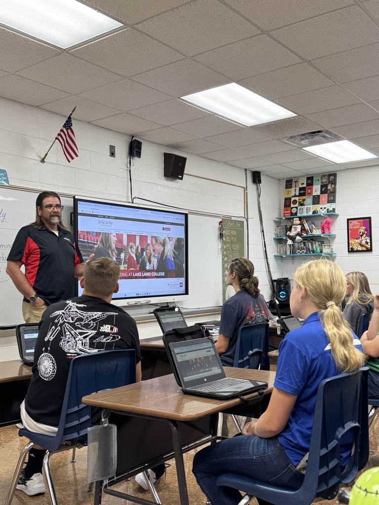 Mr. Cougill is teaching the dual credit students to use the library's database. 