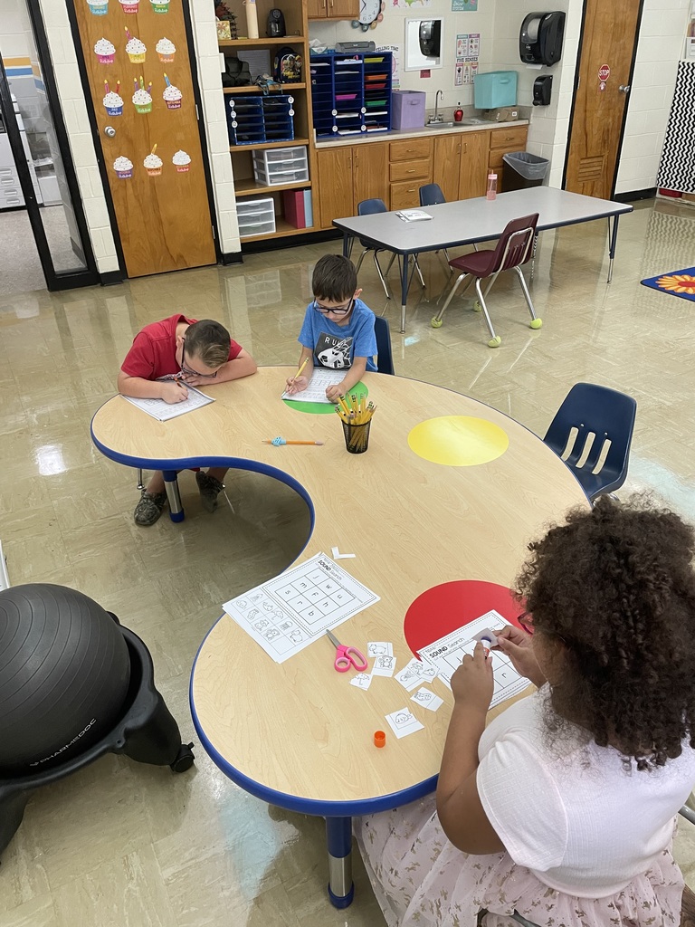Students are working on a cut and paste beginning sound activity.