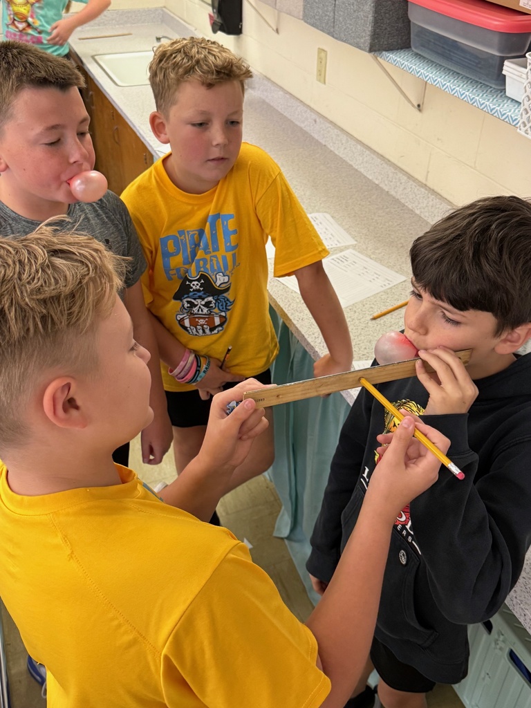 Students are blowing bubbles and measuring their size. 