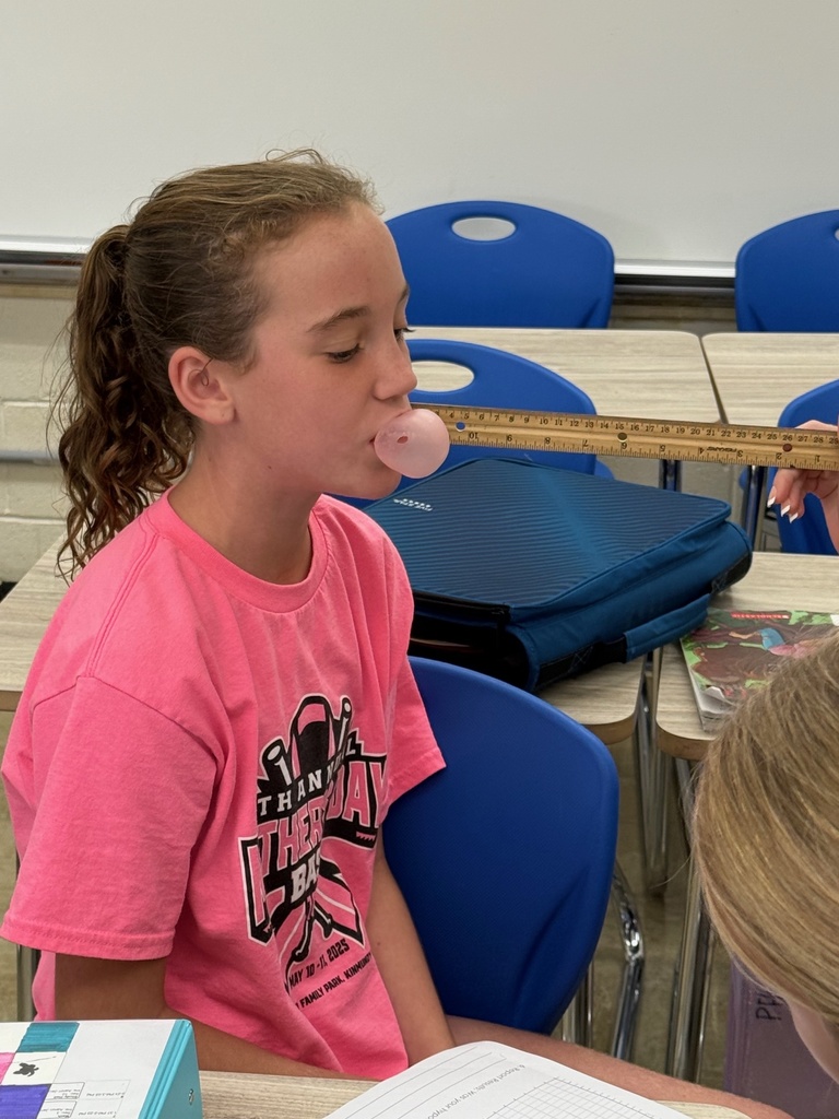 Students are blowing bubbles and measuring their size. 