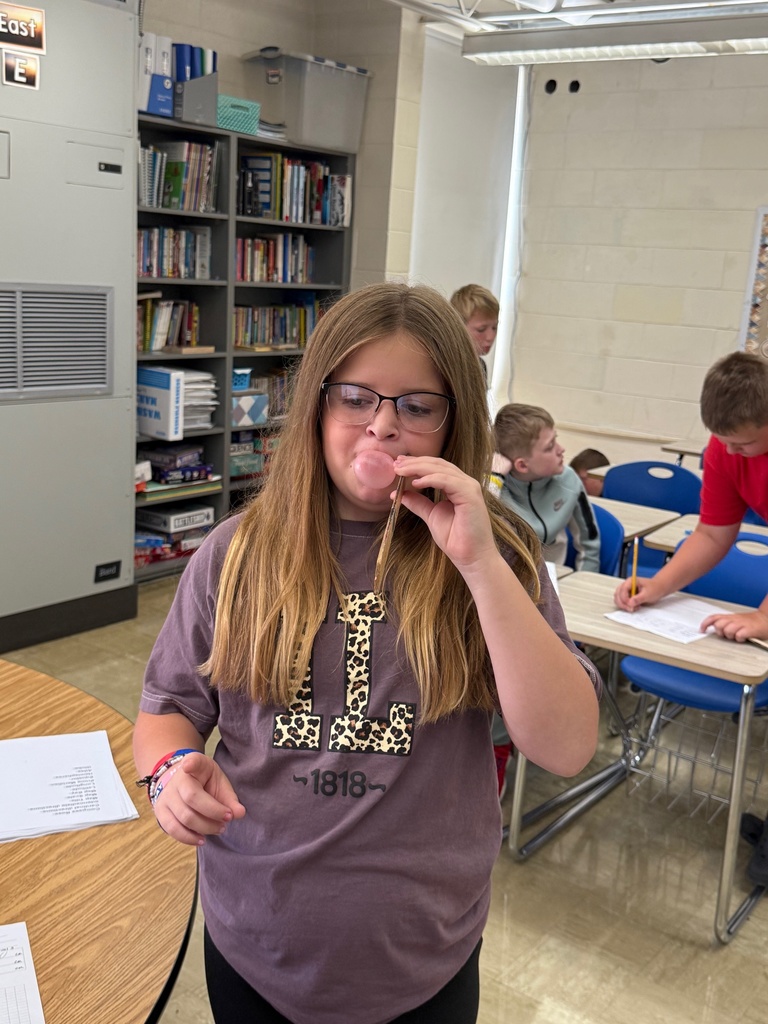 Students are blowing bubbles and measuring their size. 