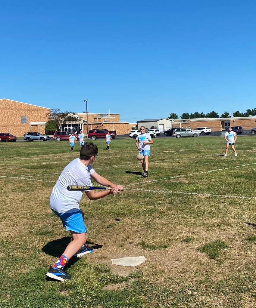 Middle school students are playing slow pitch softball.
