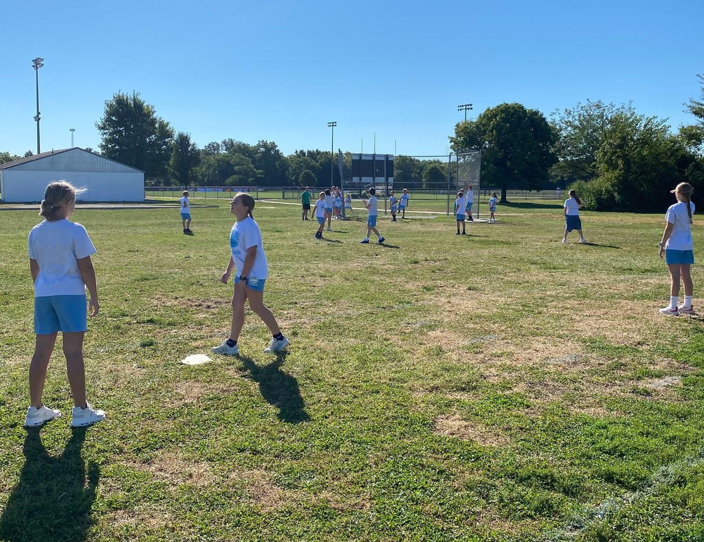 Middle school students are playing slow pitch softball.