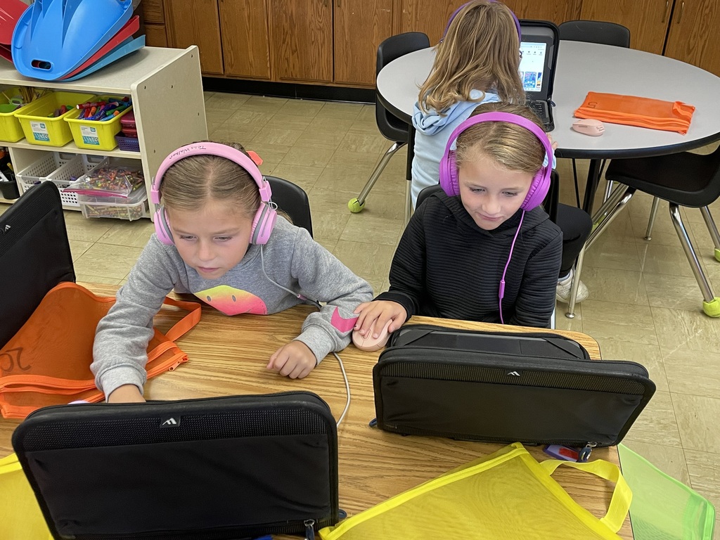 Two students are listening to a story.