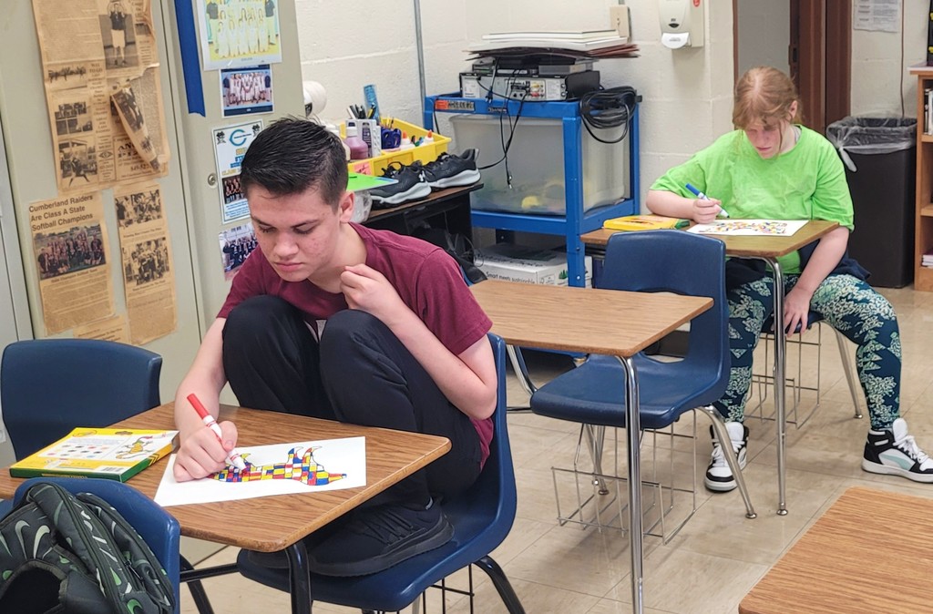 Students are working on their Mondrian art projects.