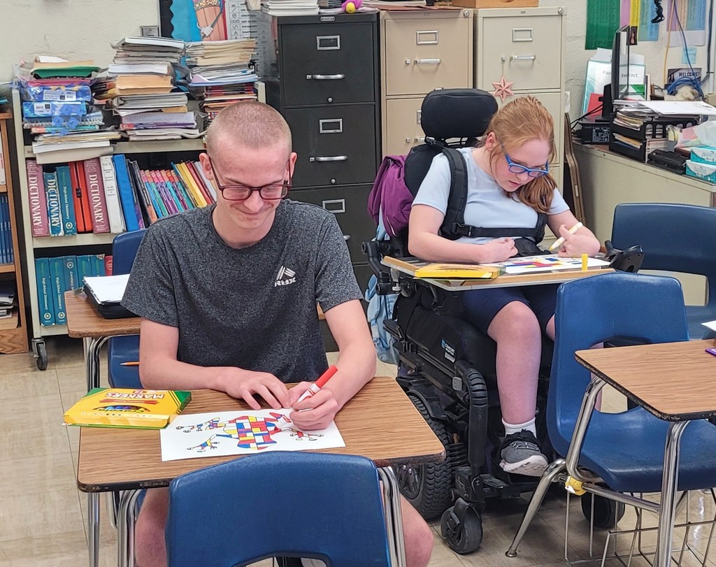 Students are working on their Mondrian art projects.