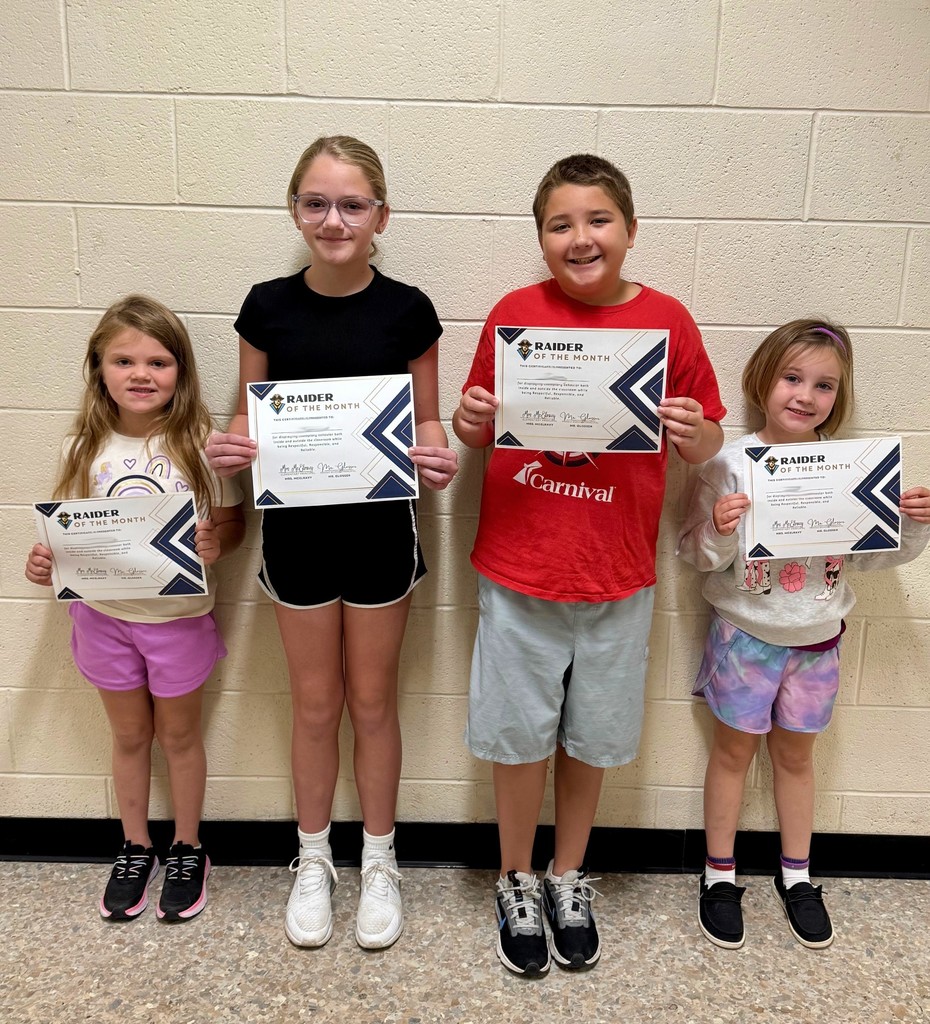The four students are Raiders of the Month. They are holding their certificates.