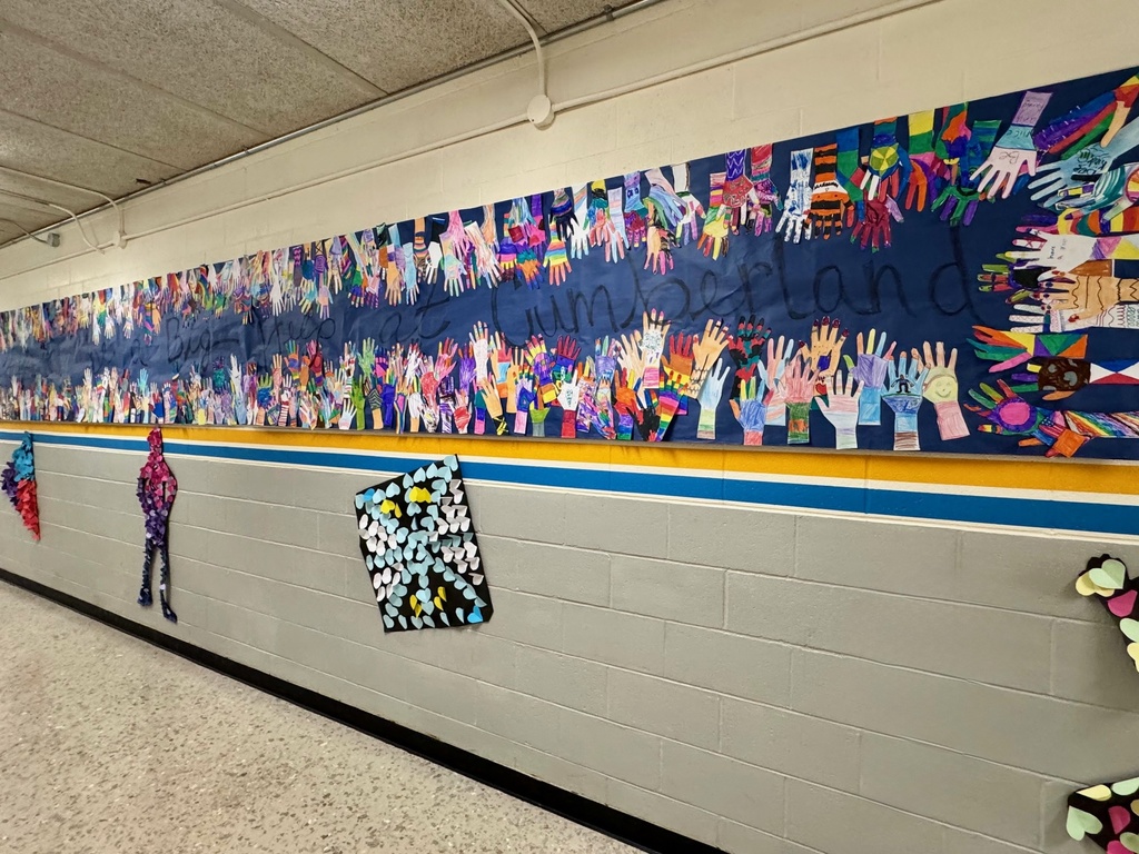Another section of the handprint mural, with the full phrase reading “Small Hands Can Make a Big Difference.” Below it are black silhouette figures filled with colorful hearts and geometric paper shapes.