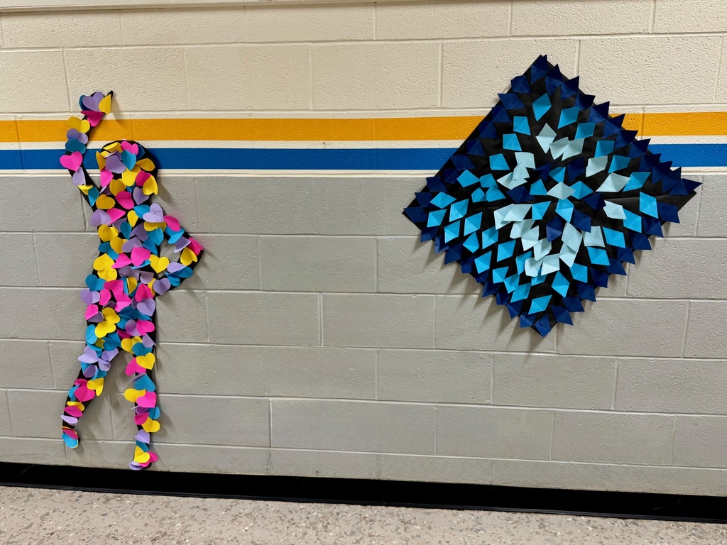 A black silhouette of a person reaching upward, covered in multicolored heart cutouts. Next to it is a diamond-shaped collage of folded blue paper shapes forming a bold geometric pattern.